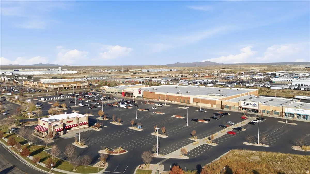 Aerial view of a mountain backdrop and a commercial area