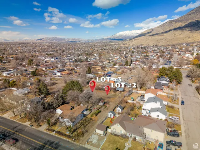 Aerial overview of property's location with nearby suburban area and mountains