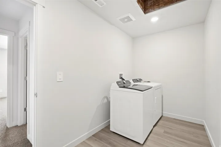 ***DISCLAIMER** Exterior & Interior finishes may vary. Washroom featuring washer and dryer, light wood-style floors, and recessed lighting