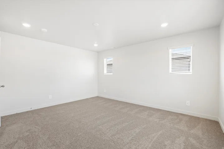 ***DISCLAIMER** Exterior & Interior finishes may vary. Spare room featuring light colored carpet and recessed lighting