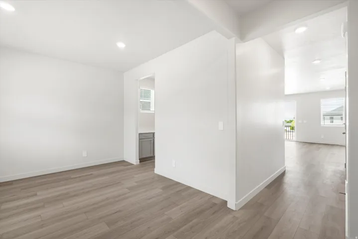 ***DISCLAIMER** Exterior & Interior finishes may vary. Empty room with light wood-style floors, healthy amount of natural light, and recessed lighting