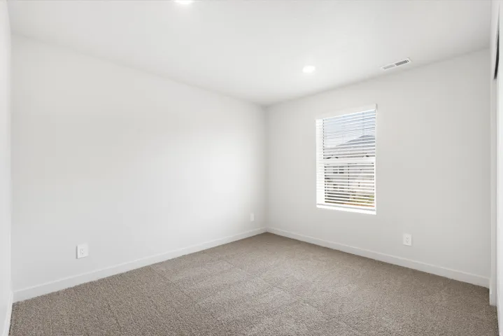 ***DISCLAIMER** Exterior & Interior finishes may vary. Carpeted spare room featuring baseboards and recessed lighting