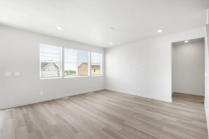 ***DISCLAIMER** Exterior & Interior finishes may vary. Spare room with light wood finished floors and recessed lighting