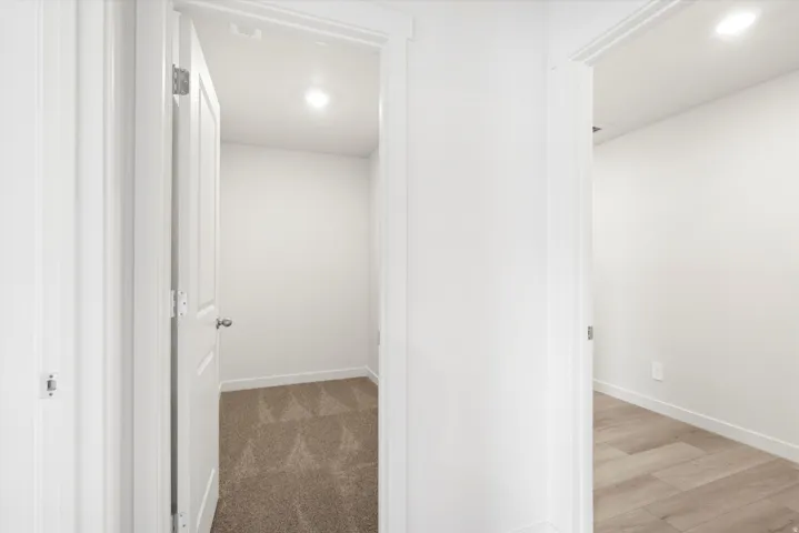 ***DISCLAIMER** Exterior & Interior finishes may vary. Hallway with recessed lighting and light colored carpet