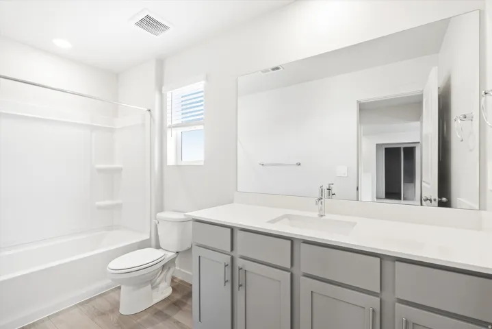 ***DISCLAIMER** Exterior & Interior finishes may vary. Full bath featuring vanity, shower / bath combination, and light wood finished floors