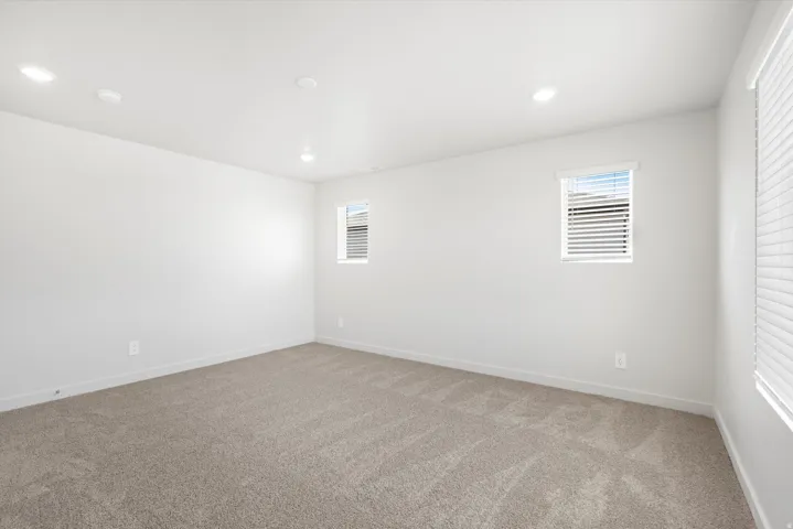 ***DISCLAIMER** Exterior & Interior finishes may vary. Unfurnished room featuring light carpet, healthy amount of natural light, and recessed lighting