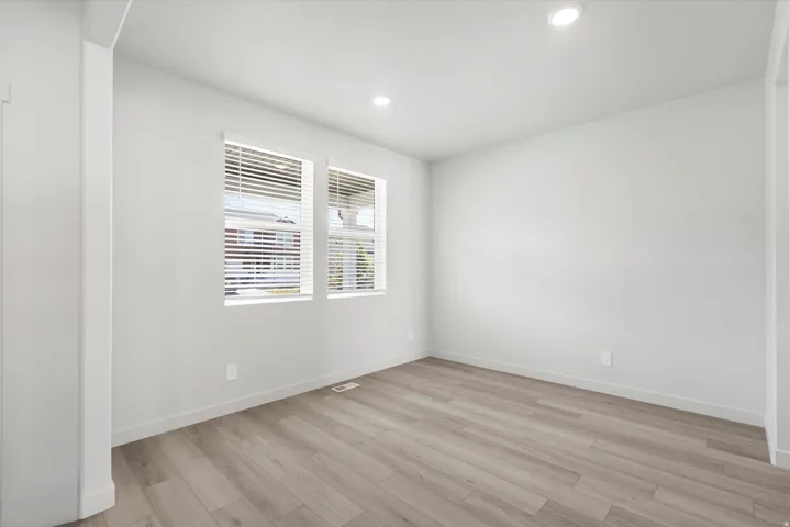 ***DISCLAIMER** Exterior & Interior finishes may vary. Spare room featuring light wood-type flooring and recessed lighting
