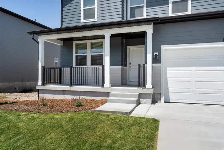 ***DISCLAIMER** Exterior & Interior finishes may vary. View of exterior entry featuring covered porch and a lawn