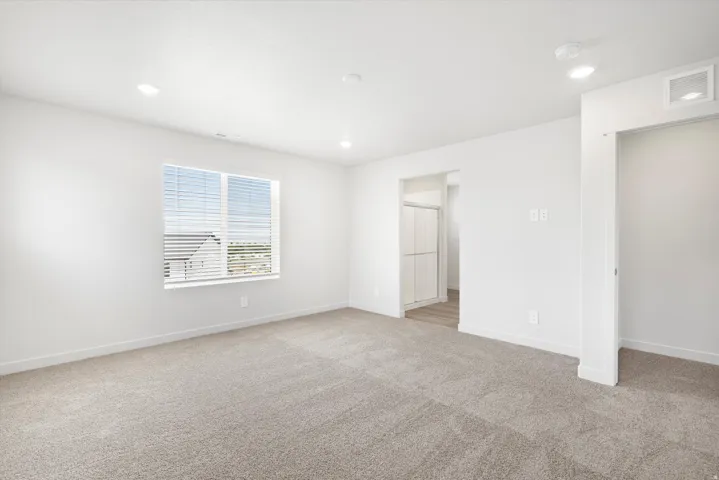 ***DISCLAIMER** Exterior & Interior finishes may vary. Unfurnished bedroom with light carpet and recessed lighting