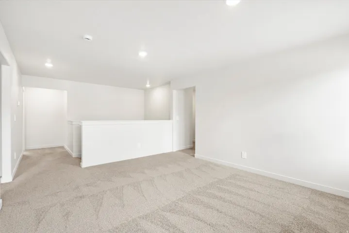 ***DISCLAIMER** Exterior & Interior finishes may vary. Unfurnished room featuring light colored carpet and recessed lighting