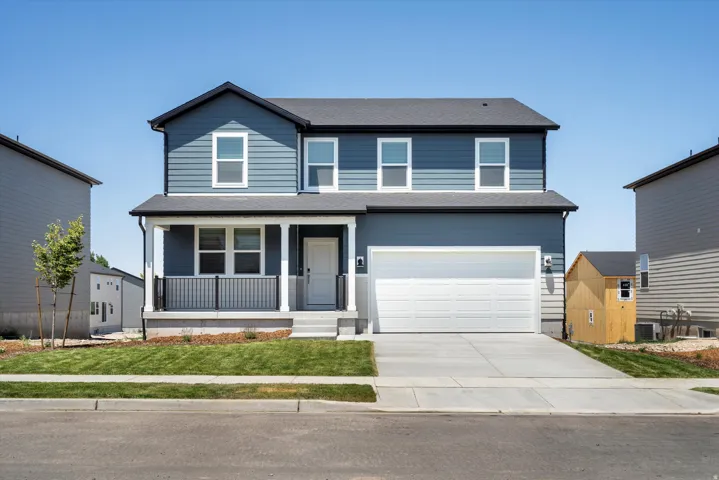 ***DISCLAIMER** Exterior & Interior finishes may vary. View of front of house with a porch, concrete driveway, a garage, a front yard, and a shingled roof