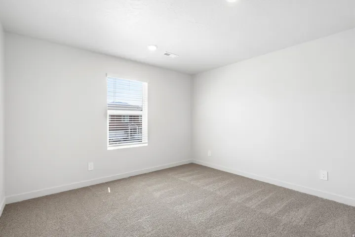 ***DISCLAIMER** Exterior & Interior finishes may vary. Empty room with light carpet and a textured ceiling
