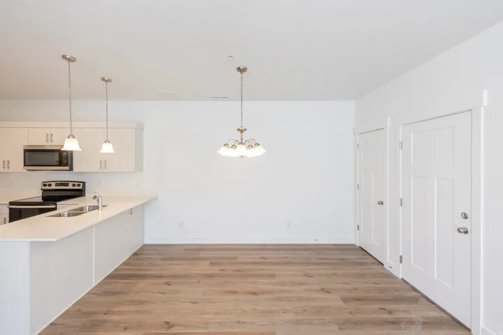 Open concept living space featuring wood-finish flooring