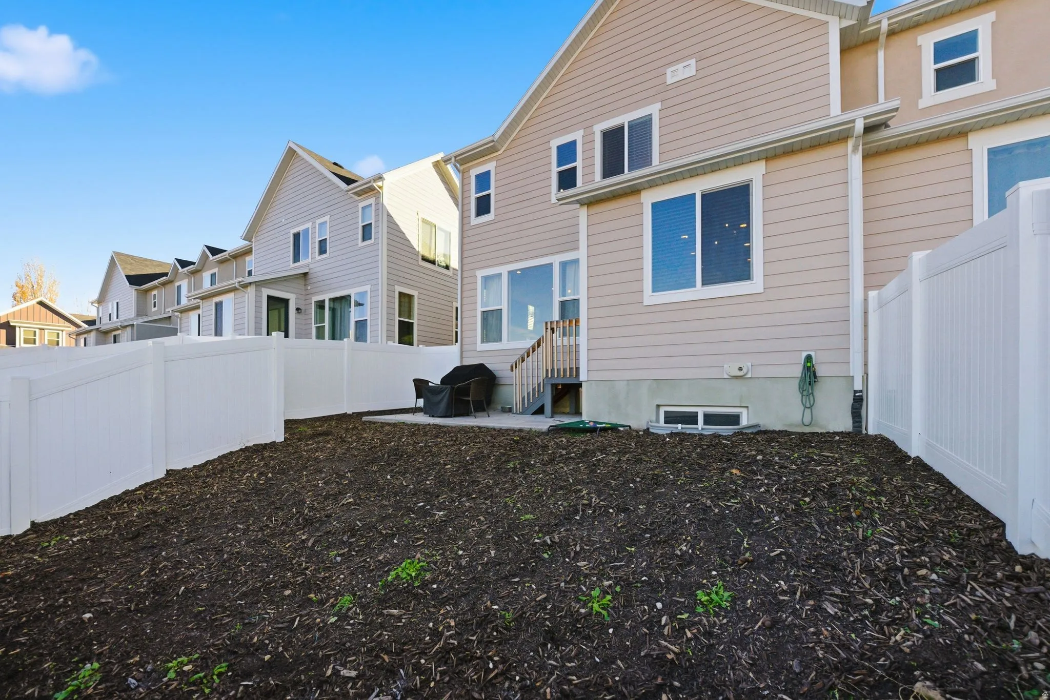 Back of house with a patio area, a fenced backyard, and a residential view