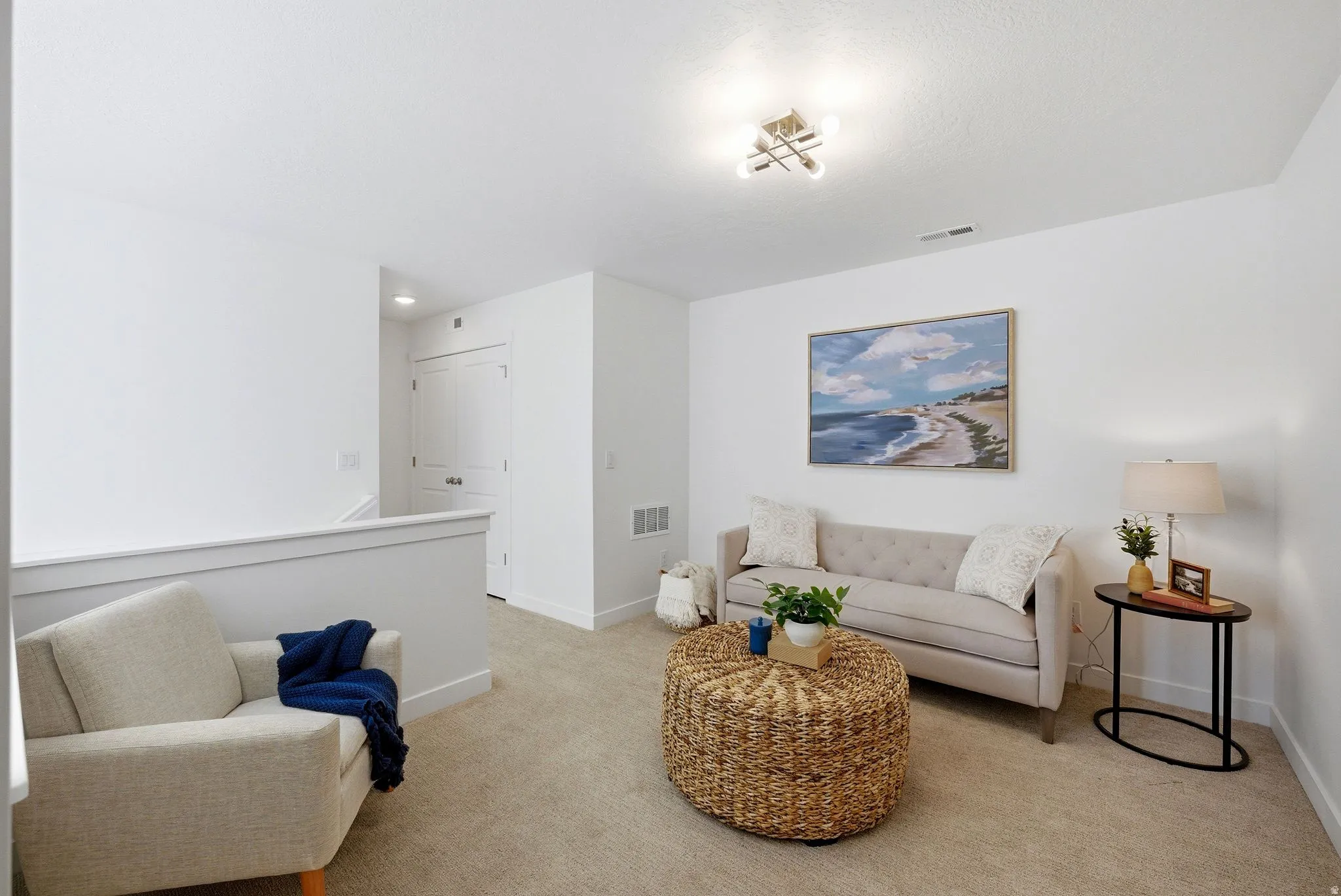 Living room with light carpet and baseboards
