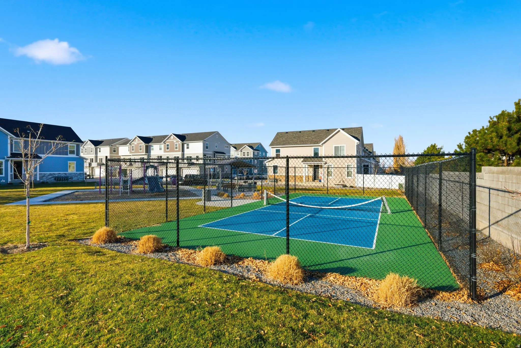View of tennis court featuring a residential view