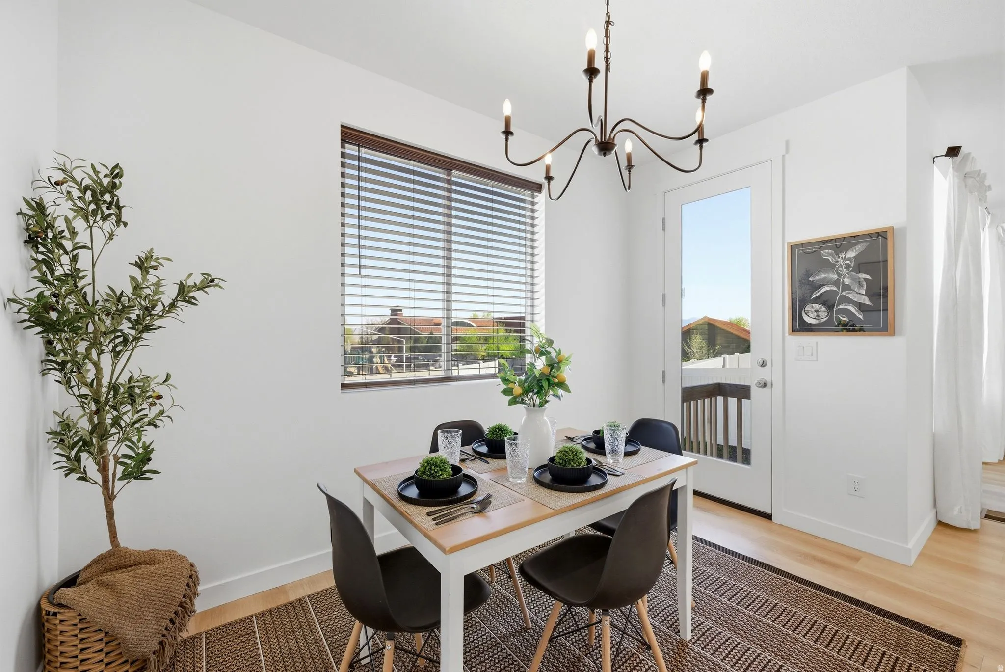 Dining area featuring suspended lighting and light wood-type flooring
