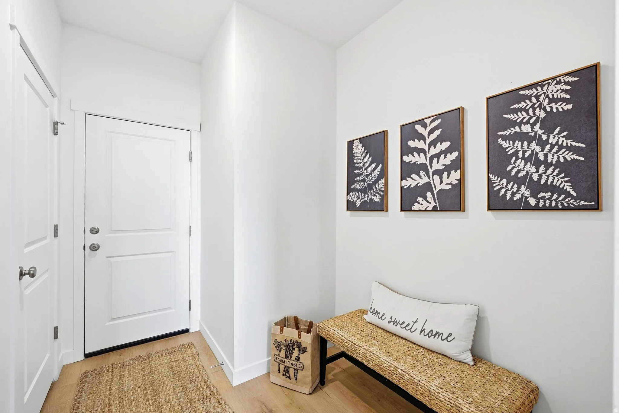Corridor featuring light wood-type flooring and baseboards