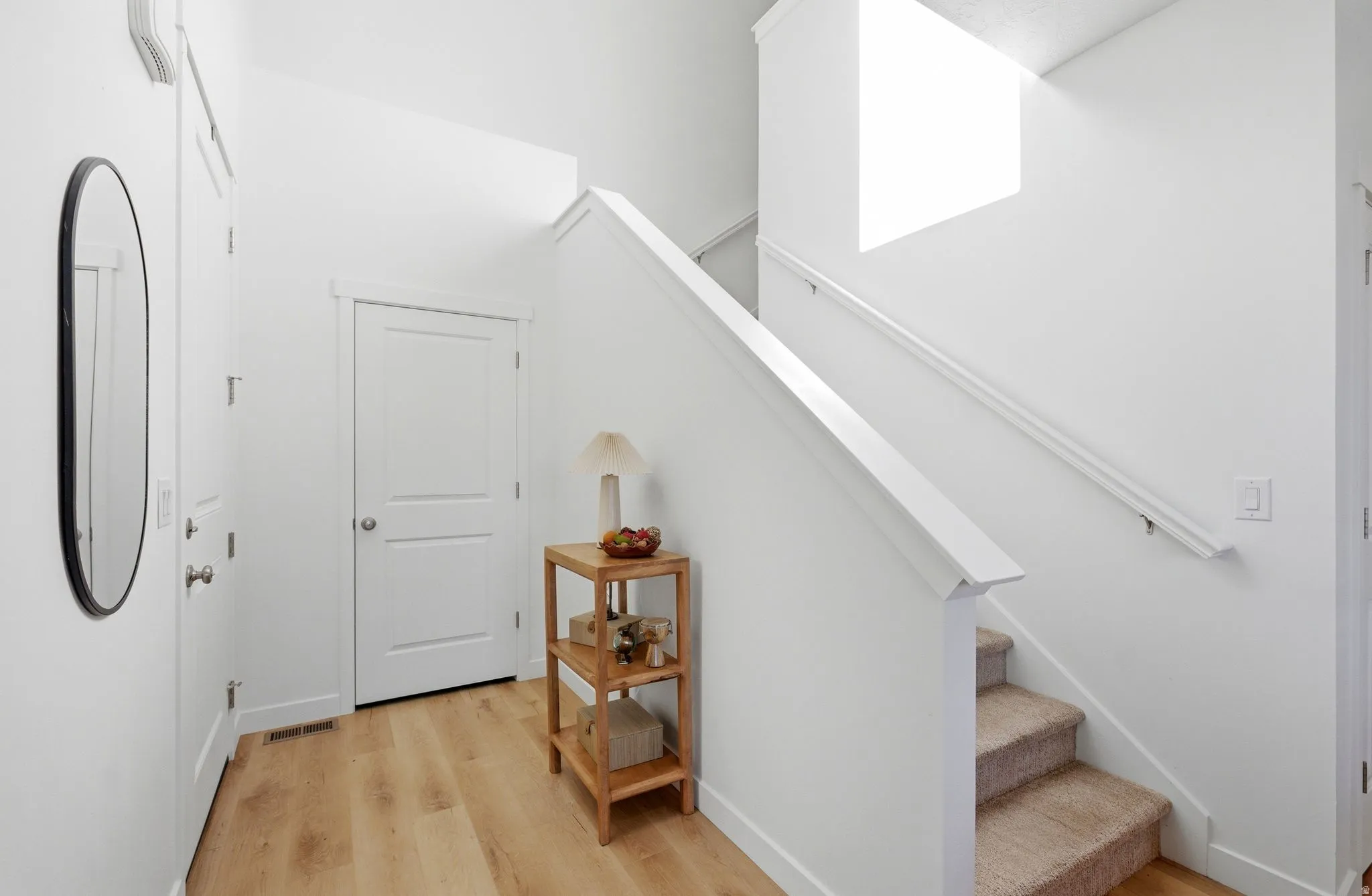 Stairway featuring wood finished floors