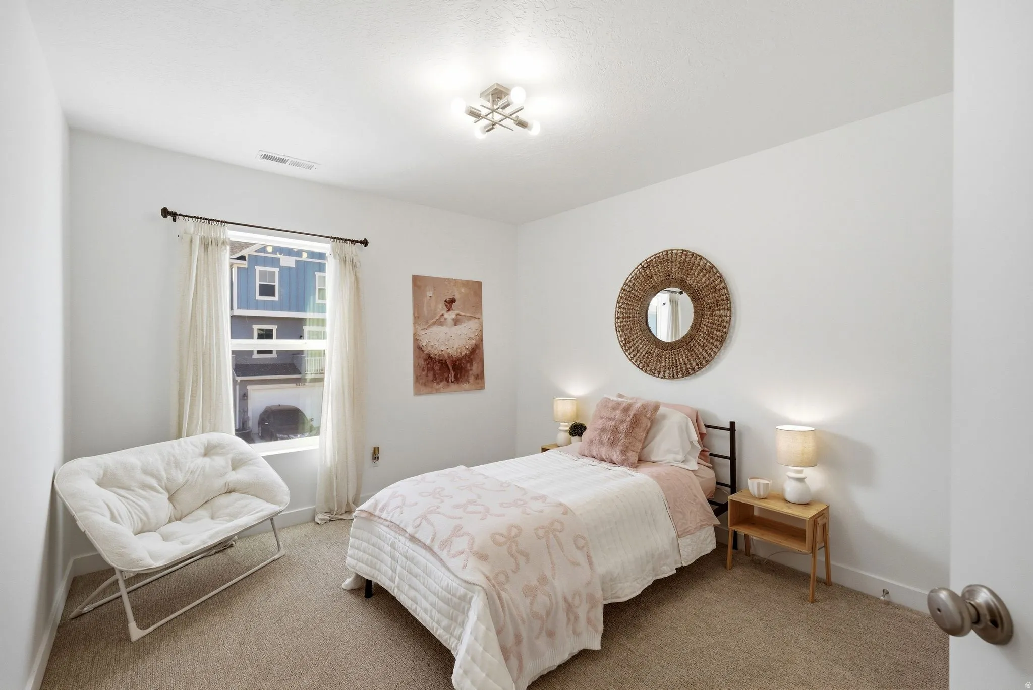 Bedroom featuring light carpet and baseboards