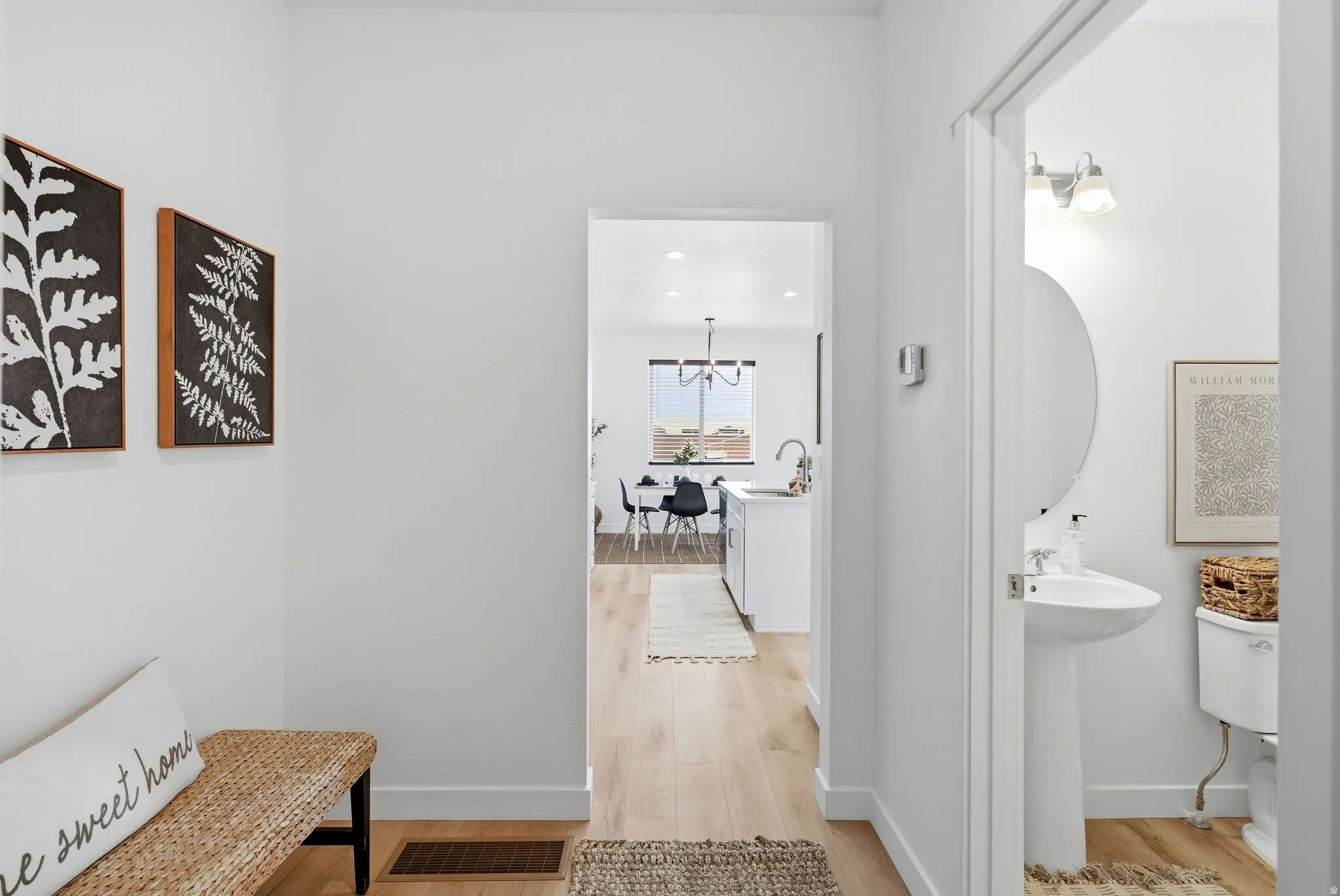 Corridor featuring light wood-type flooring and recessed lighting