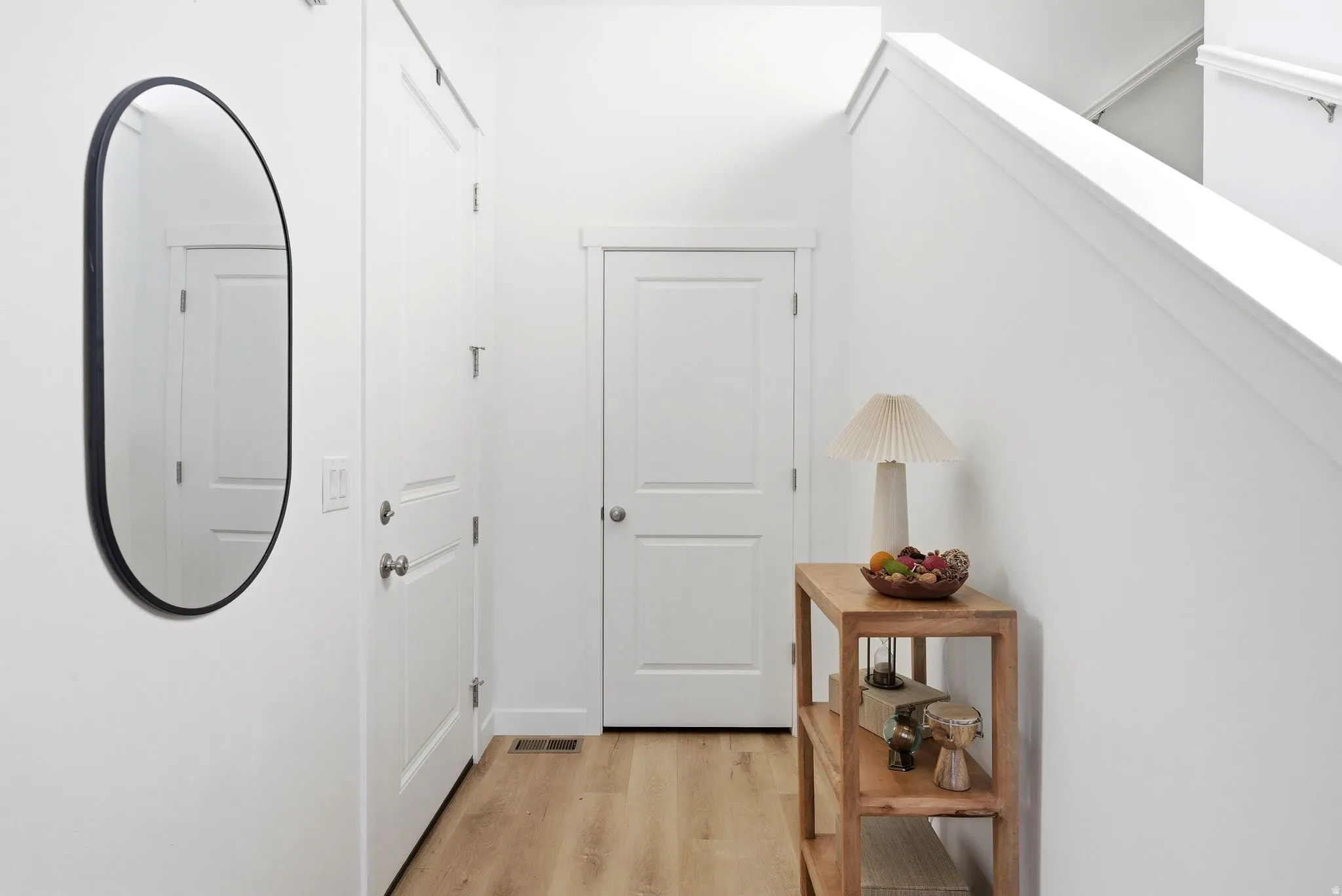 Hallway featuring light wood-style floors
