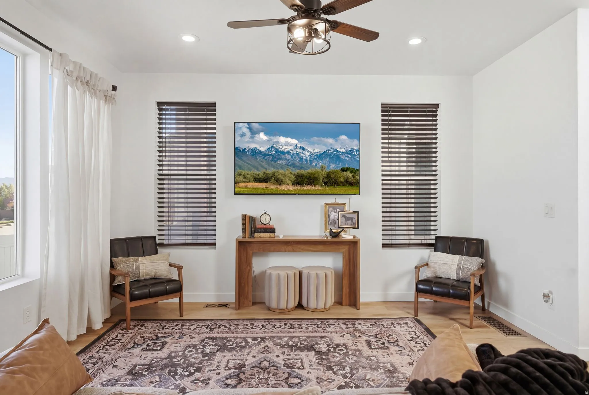 Living area featuring a ceiling fan, wood finished floors, and recessed lighting