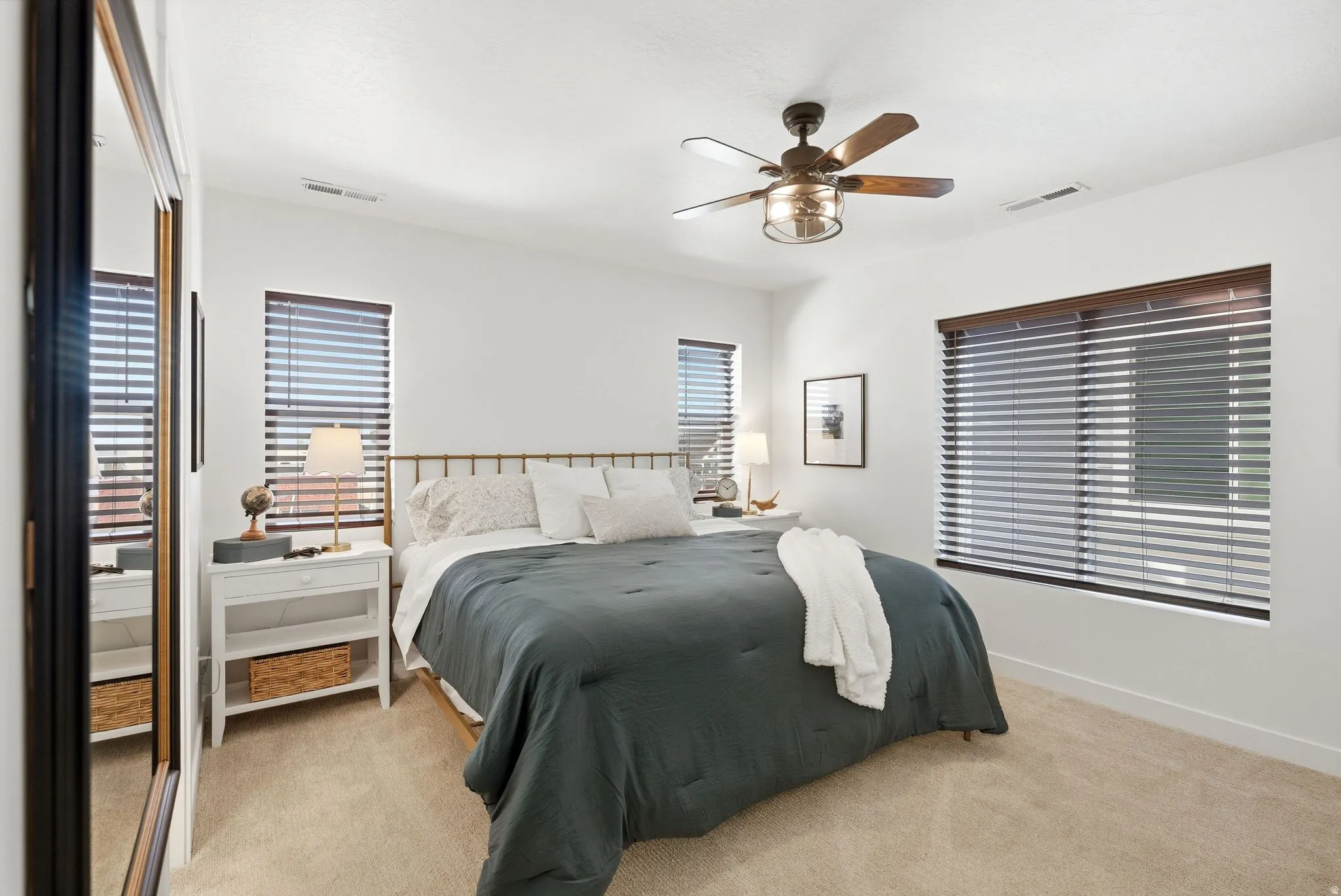 Bedroom featuring light colored carpet and a ceiling fan