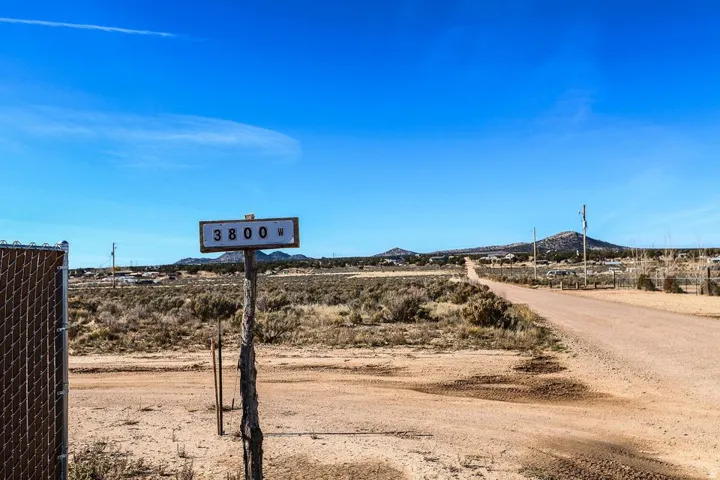 View of dirt / gravel road featuring a rural view and a mountain view