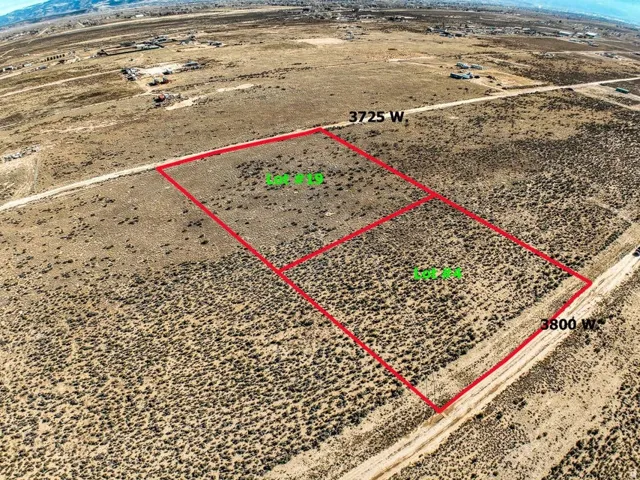 Overview of rural landscape with property parcel outlined and a mountain backdrop