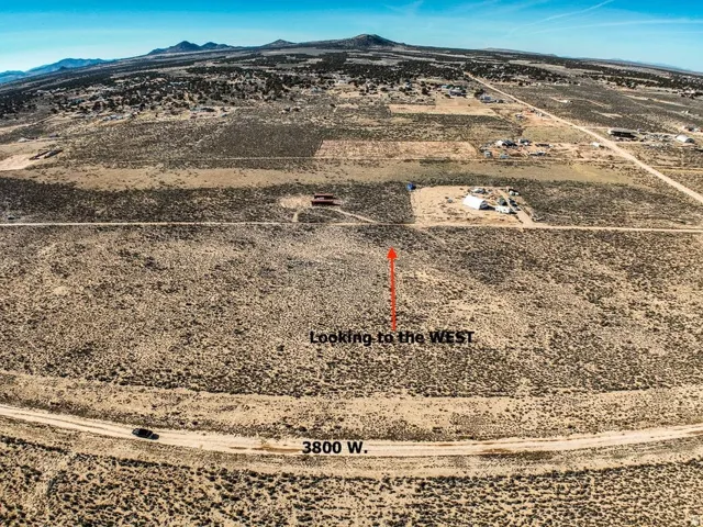 Aerial view of sparsely populated area featuring mountains and a desert landscape