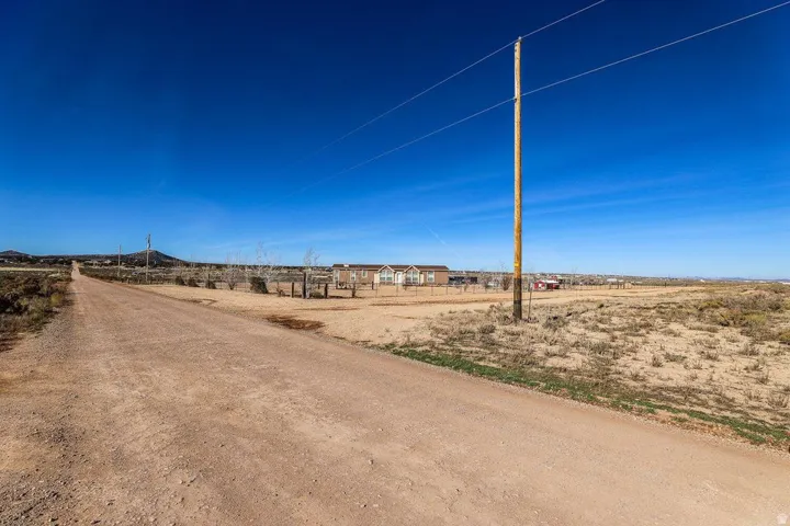 View of dirt / gravel road featuring a rural view