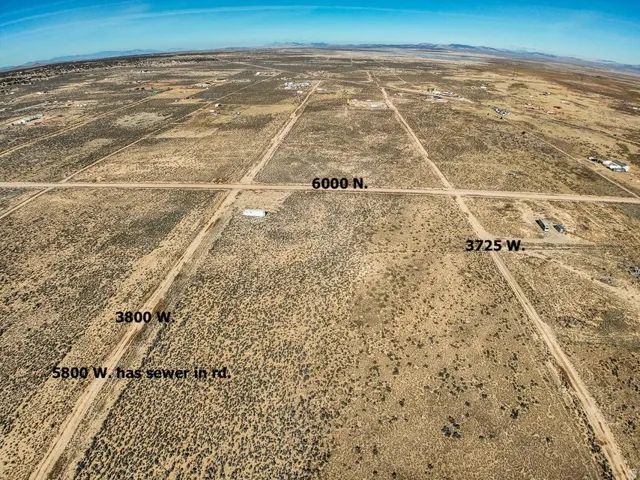 Aerial view of sparsely populated area featuring a desert landscape and mountains