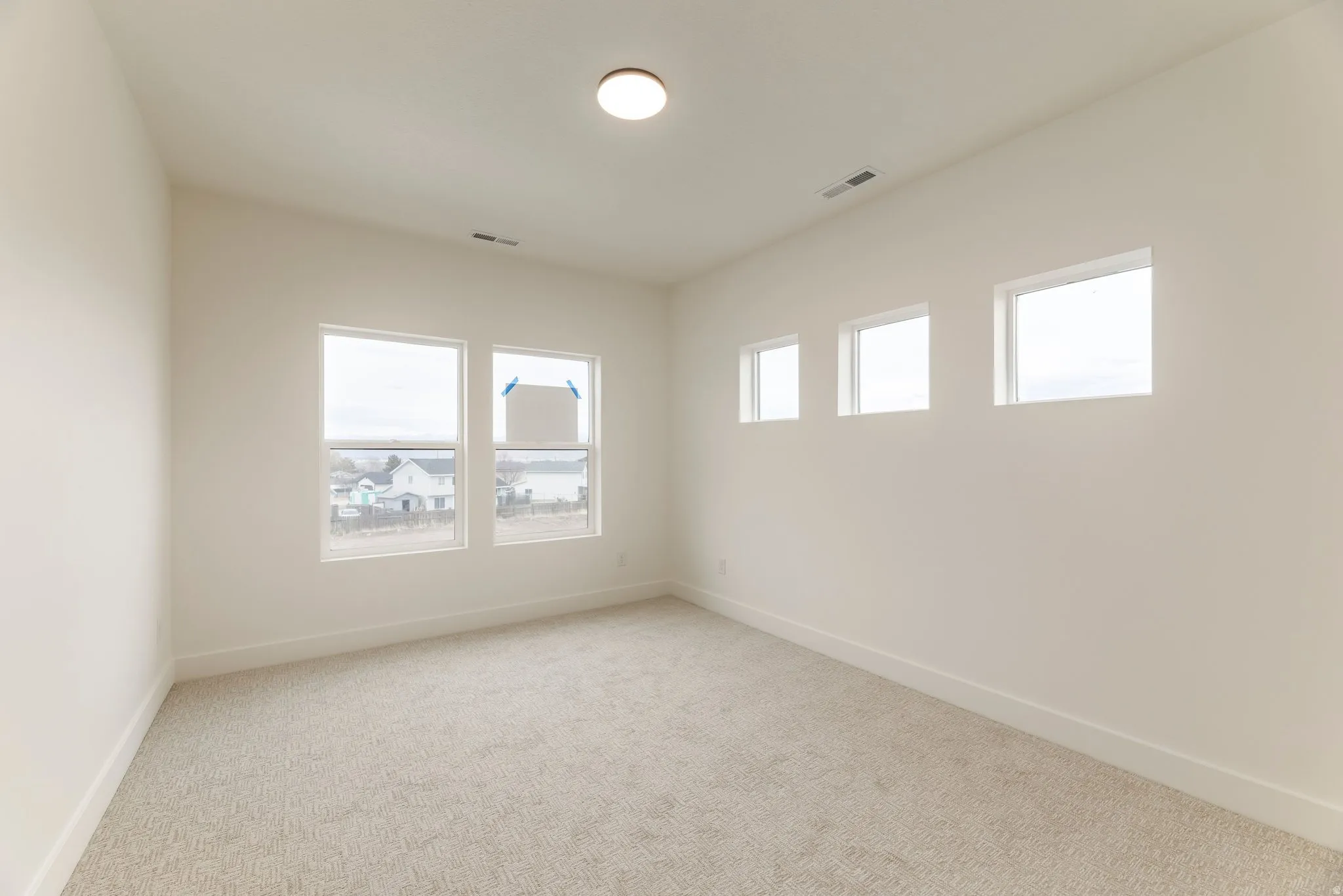 Spare room with light carpet and healthy amount of natural light