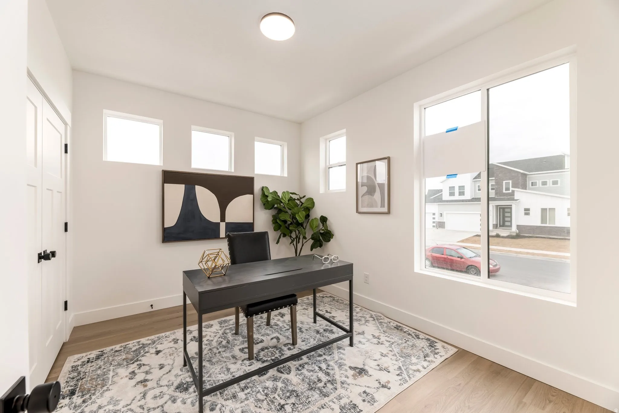 Office area featuring light wood-style floors