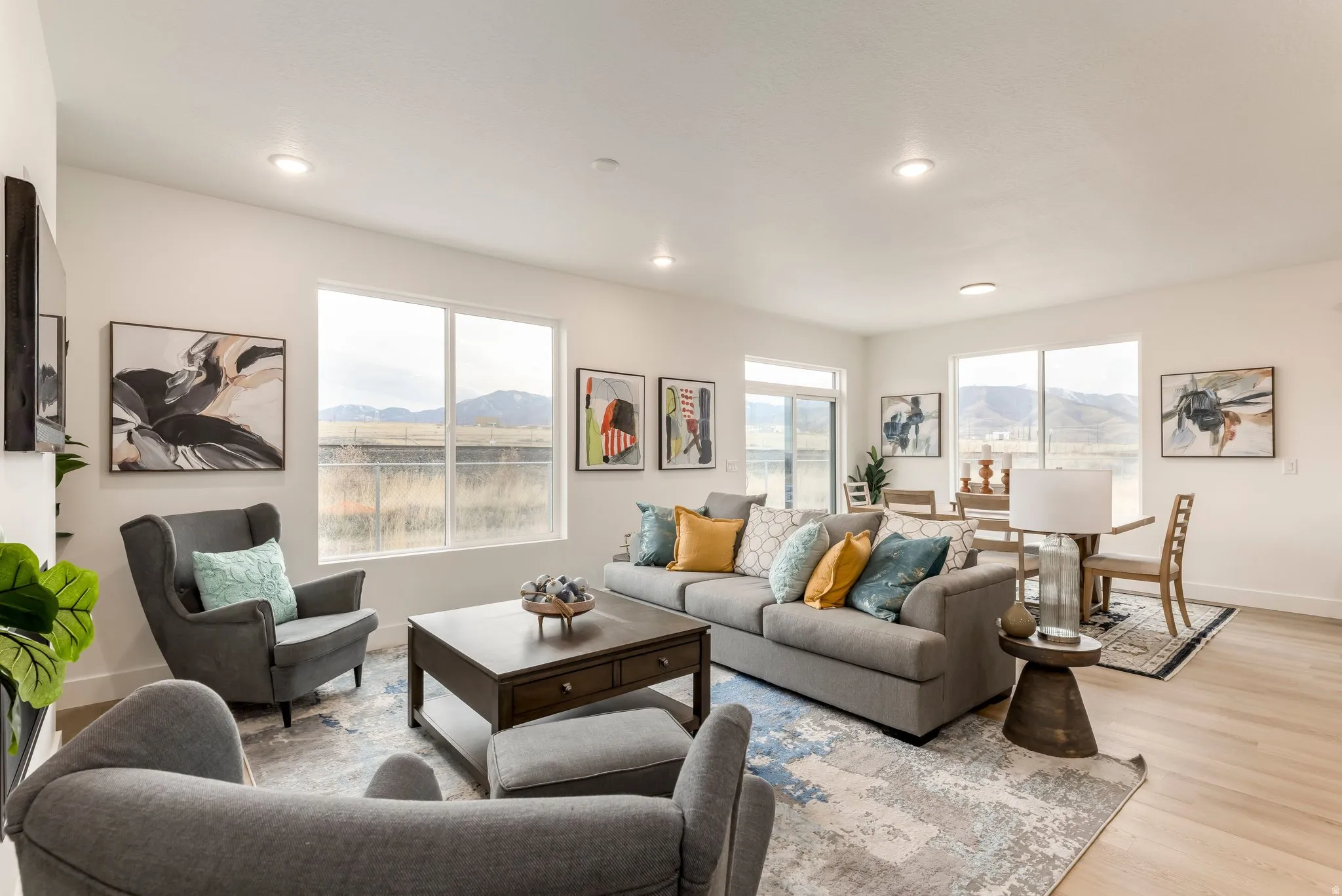Living area featuring a mountain view, light wood finished floors, and recessed lighting