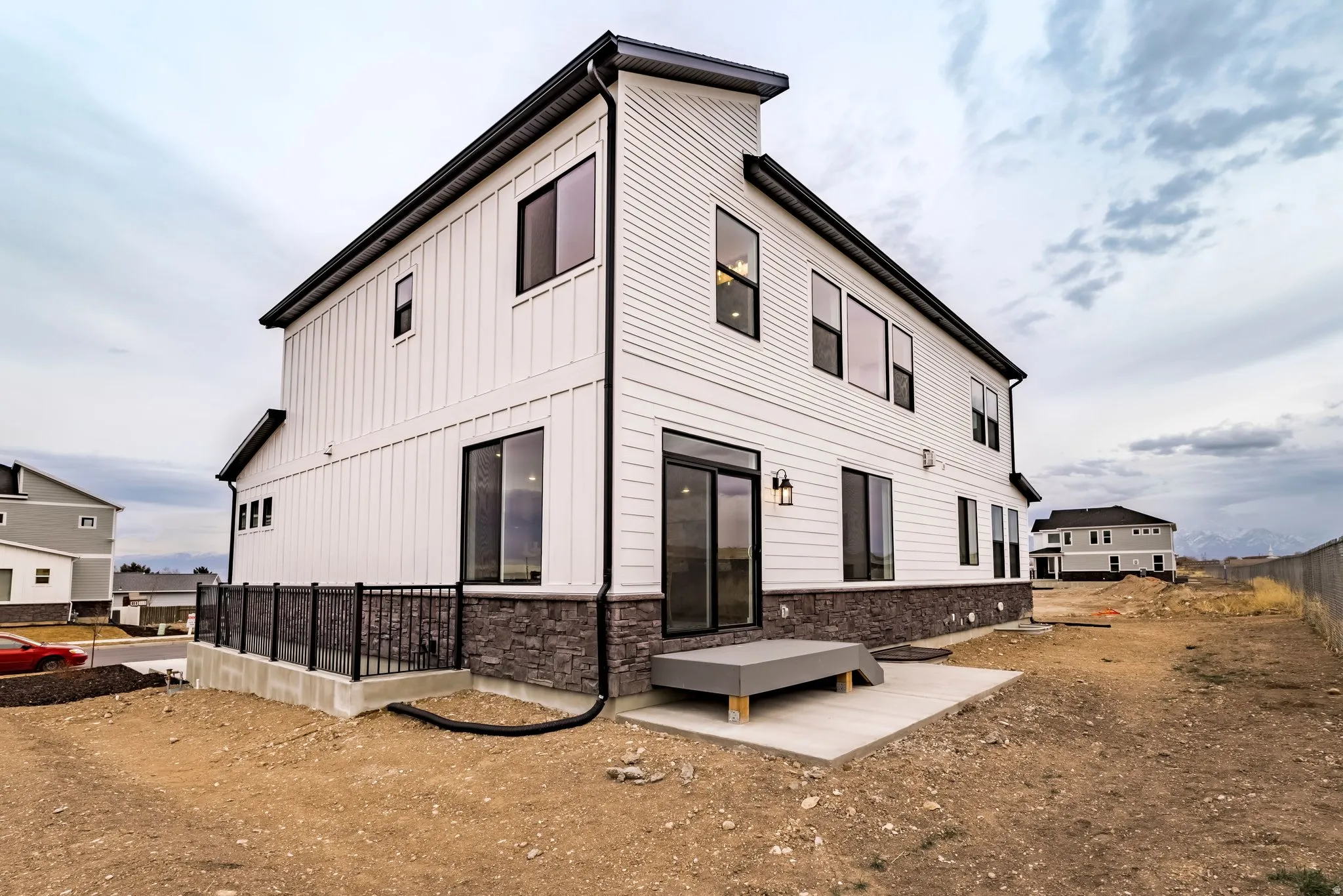 Rear view of property featuring stone siding and board and batten siding