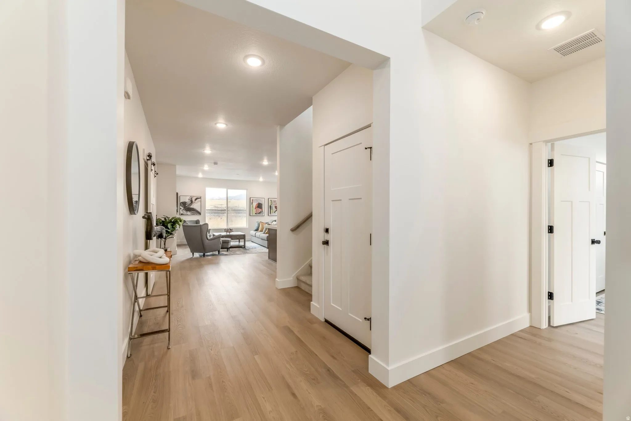 Corridor featuring light wood finished floors and recessed lighting