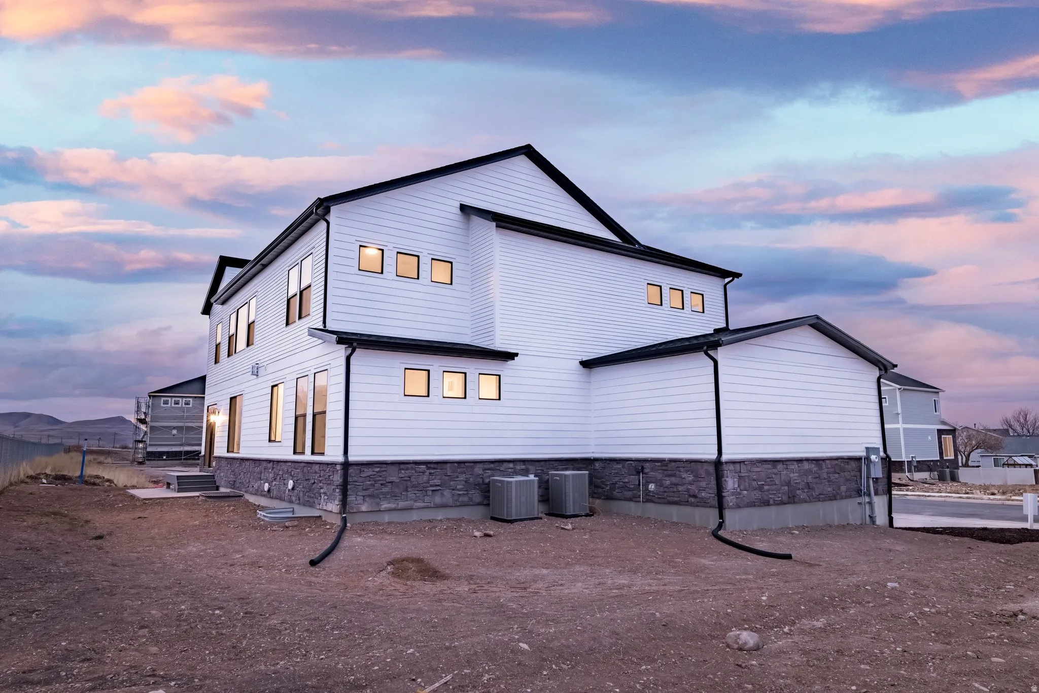 View of back of house at dusk