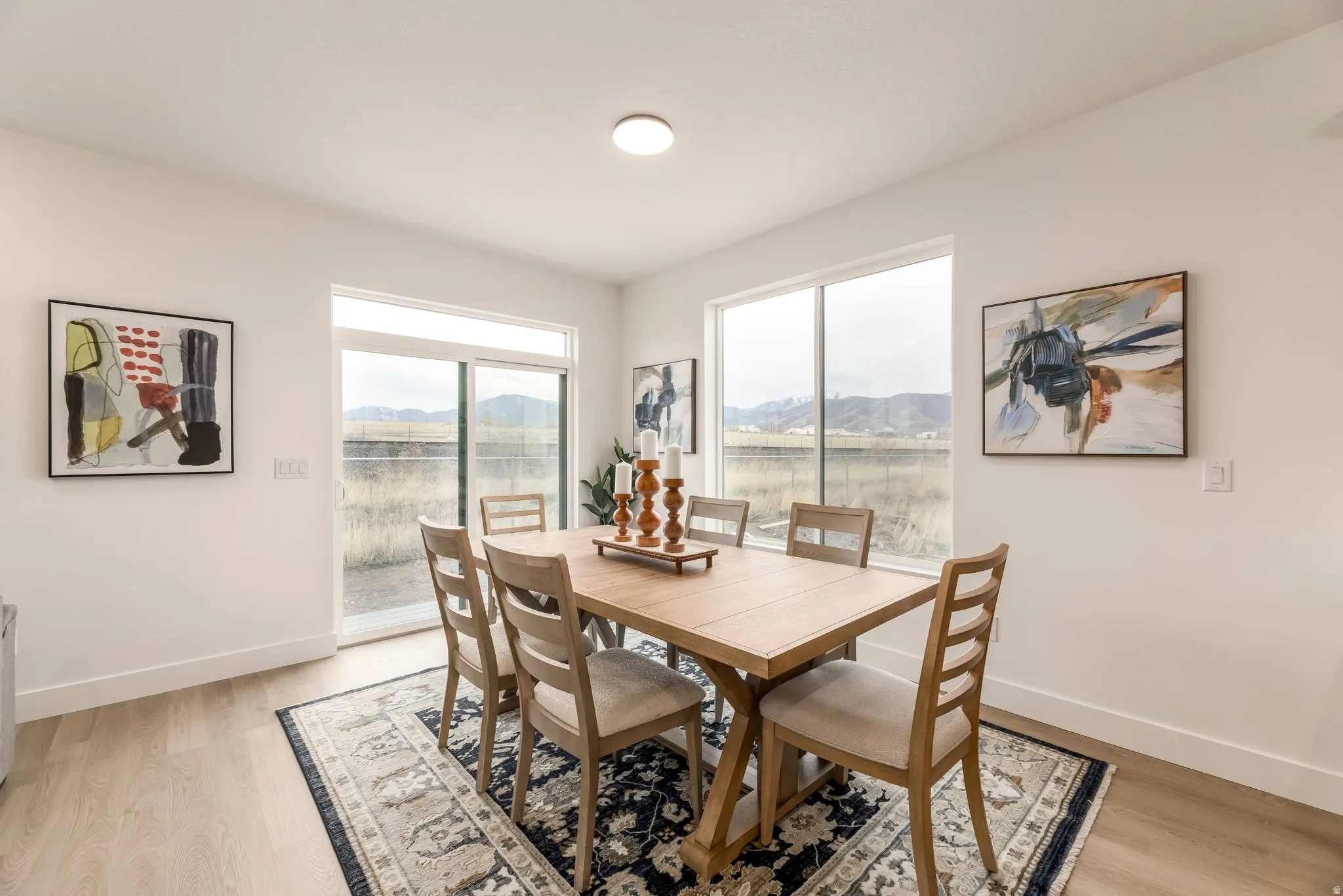 Dining area featuring healthy amount of natural light, a mountain view, and light wood-type flooring