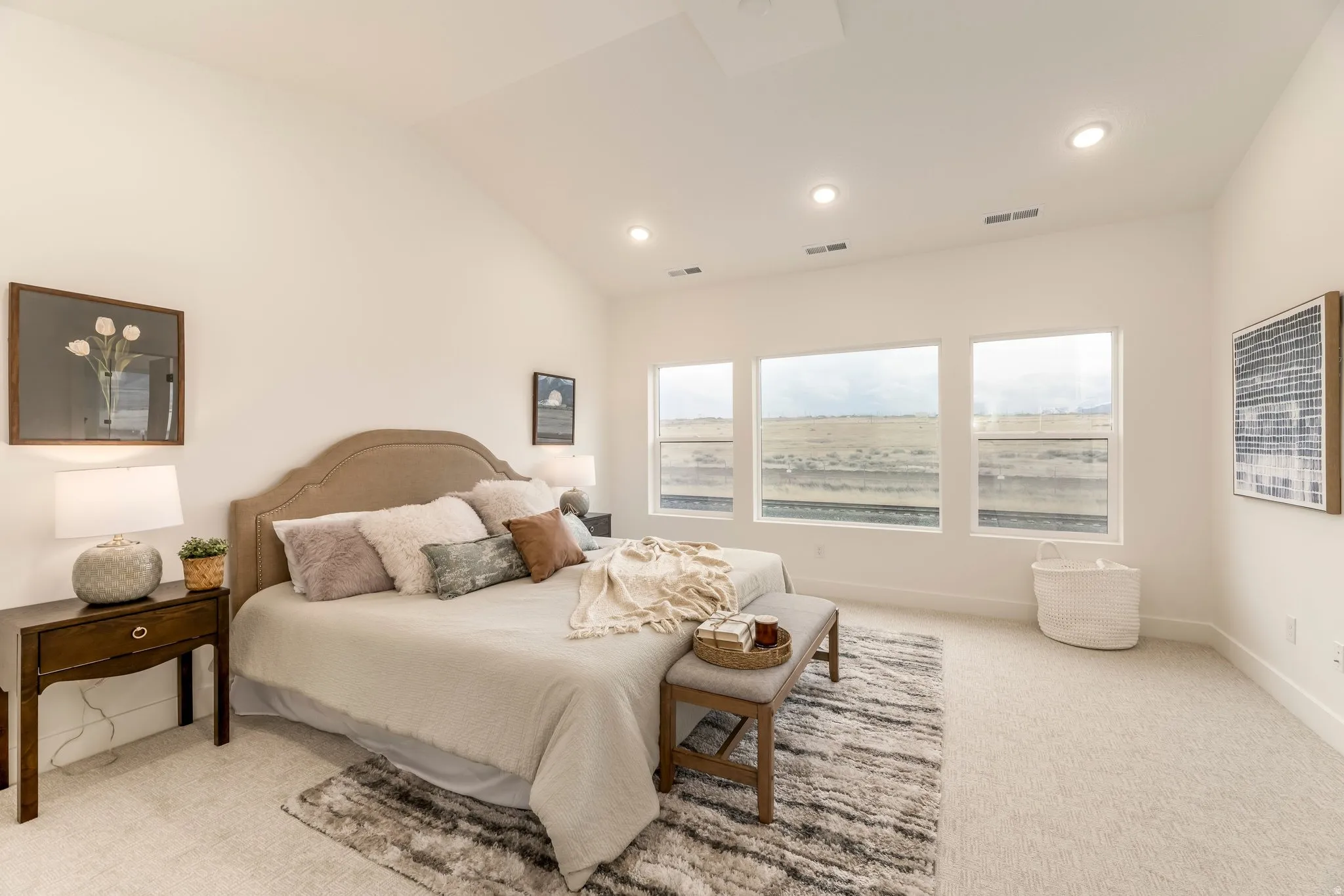 Bedroom featuring light carpet, lofted ceiling, and recessed lighting