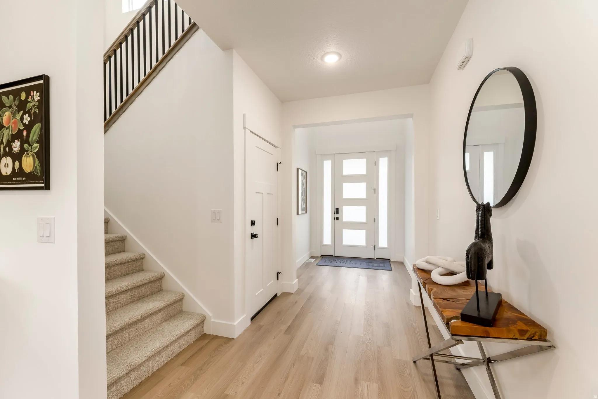 Entryway with stairway and light wood finished floors