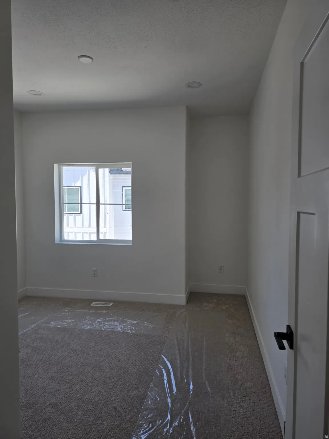 Bed room featuring dark carpet and recessed lighting