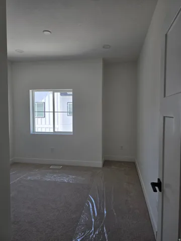 Bed room featuring dark carpet and recessed lighting