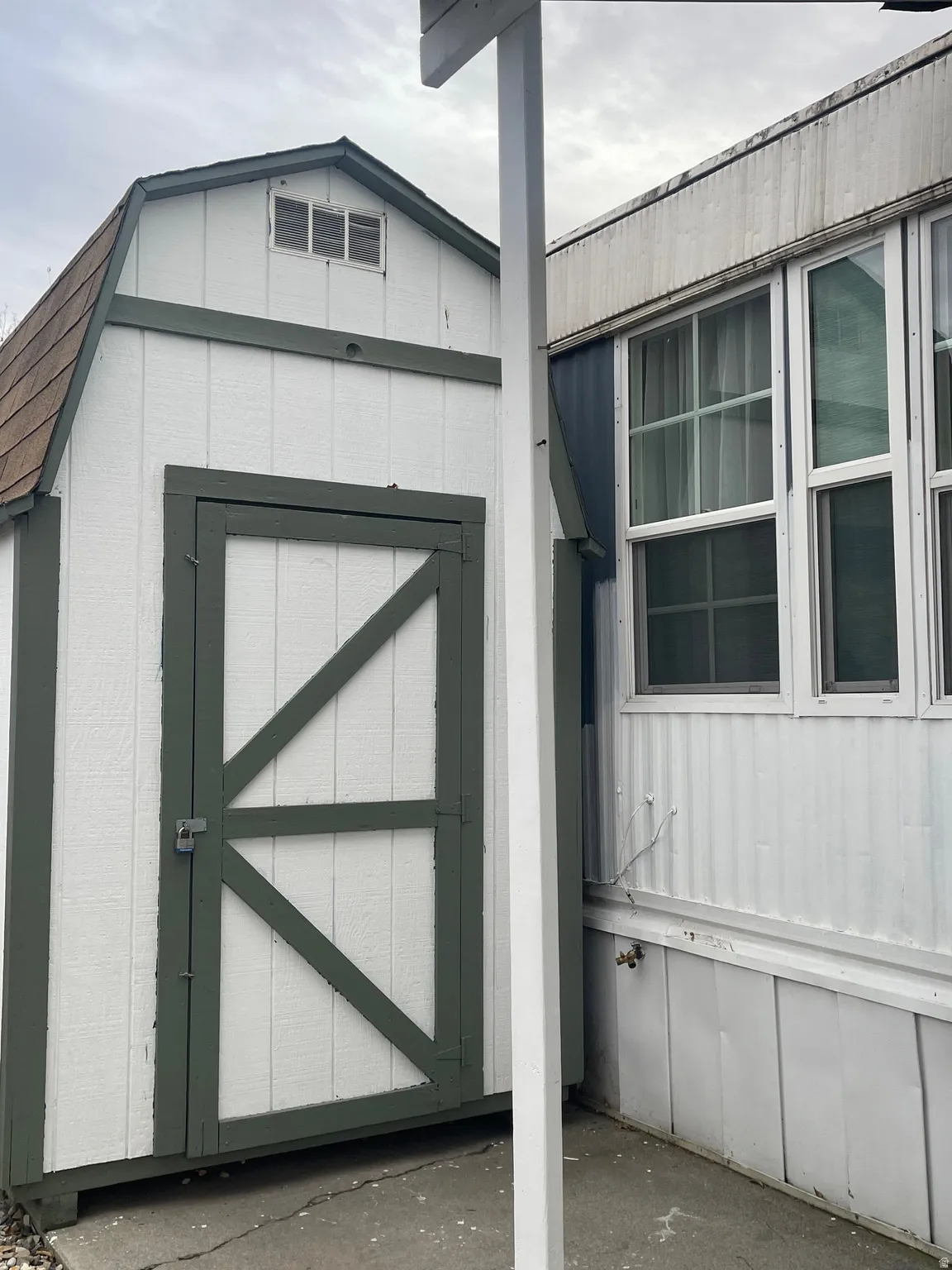Doorway to property featuring a gambrel roof