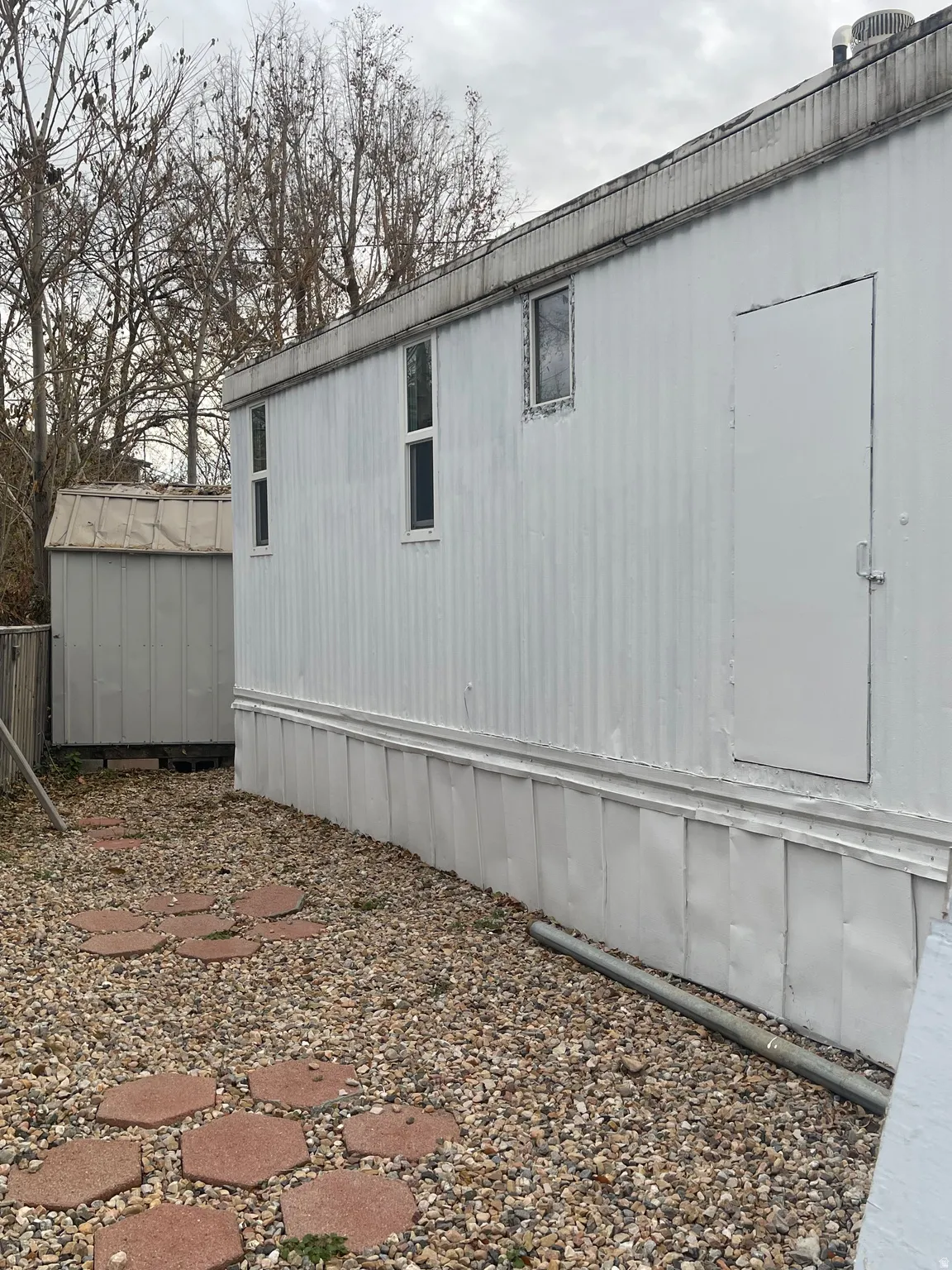 View of home's exterior with a shed