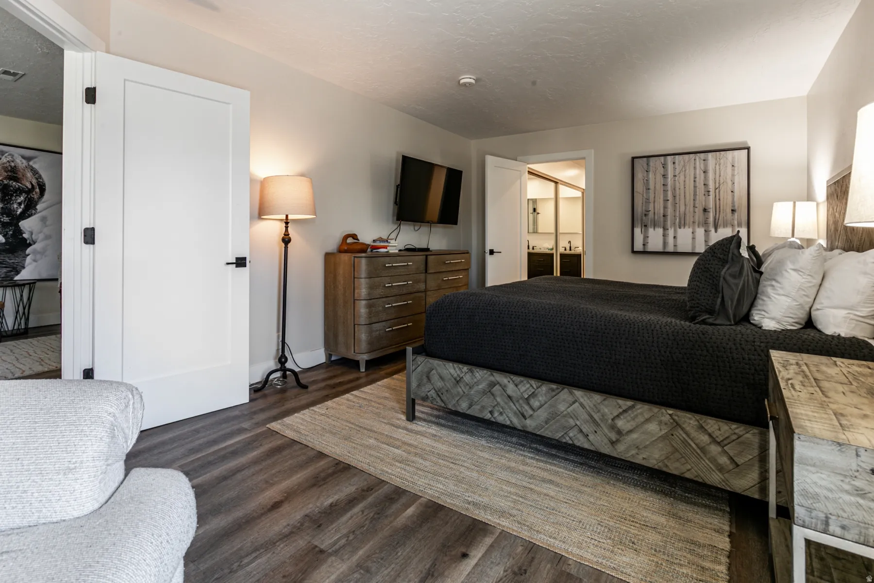 Bedroom with dark wood finished floors and a textured ceiling