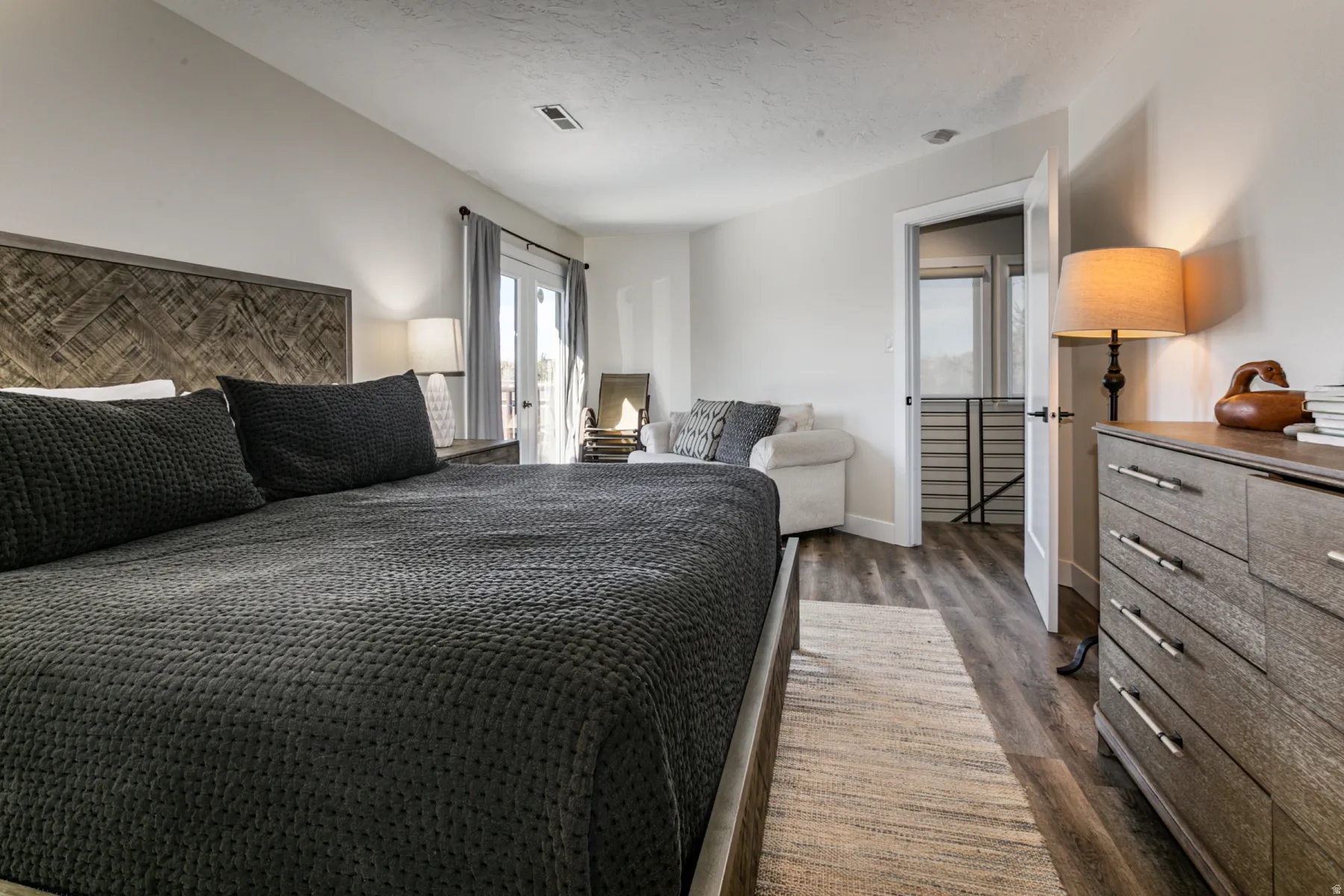 Bedroom featuring dark wood-type flooring and a textured ceiling
