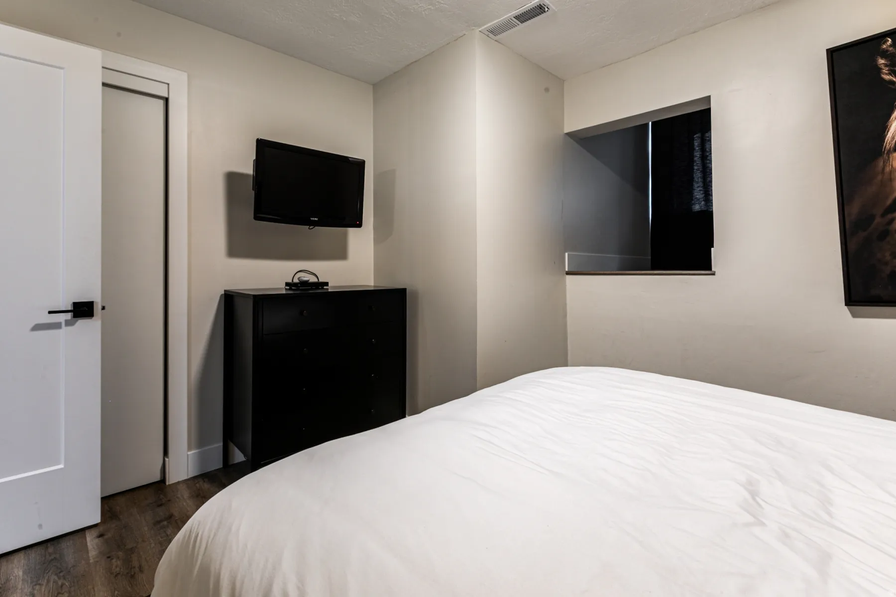Bedroom with dark wood-type flooring and a textured ceiling