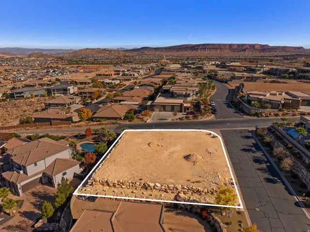 Aerial perspective of suburban area with mountains and property boundaries highlighted